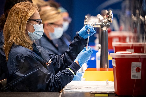 The Pfizer vaccine is prepared as the ballpark is opened as a COVID-19 Coronavirus pandemic public vaccination site on January 29, 2021 at Fenway Park in Boston, Massachusetts.
Credit: Billie Weiss/Boston Red Sox/Getty Images