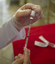 A healthcare worker prepares to administer a dose of the Pfizer-BioNTech Covid-19 vaccine to the residents at The Palace, an independent living community for seniors, at Coral Gables in Miami, Florida, United States on January 12, 2021.
Credit: Eva Marie Uzcategui Trinkl/Anadolu Agency/Getty Images