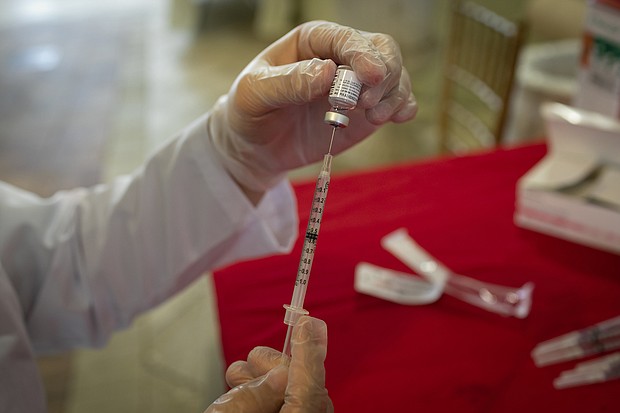 A healthcare worker prepares to administer a dose of the Pfizer-BioNTech Covid-19 vaccine to the residents at The Palace, an independent living community for seniors, at Coral Gables in Miami, Florida, United States on January 12, 2021.
Credit:	Eva Marie Uzcategui Trinkl/Anadolu Agency/Getty Images