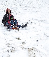 Tamra Collins and her 6-year-old son, Isaiah, happily sled down a hill at Shrader Road and Eunice Drive last Sunday in Henrico County. When 3 inches of snow hit the metro area last weekend, people took to the outdoors to enjoy the wintry landscape. People were sledding, had snowball fights and built snowmen. While this was Metro Richmond’s first big snowfall of the winter season, the area escaped the 1 to 3 feet of snow the same storm dropped on the Northeast. Much of the snow has melted already, with more wet weather on the way. Rain is expected Friday, Feb. 5, with the possibility of rain and/or snow showers on Sunday, Feb. 7. Nightly temperatures are forecast to remain at or below freezing through next week.