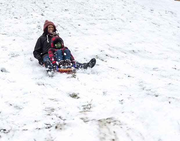 Tamra Collins and her 6-year-old son, Isaiah, happily sled down a hill at Shrader Road and Eunice Drive last Sunday in Henrico County. When 3 inches of snow hit the metro area last weekend, people took to the outdoors to enjoy the wintry landscape. People were sledding, had snowball fights and built snowmen. While this was Metro Richmond’s first big snowfall of the winter season, the area escaped the 1 to 3 feet of snow the same storm dropped on the Northeast. Much of the snow has melted already, with more wet weather on the way. Rain is expected Friday, Feb. 5, with the possibility of rain and/or snow showers on Sunday, Feb. 7. Nightly temperatures are forecast to remain at or below freezing through next week.