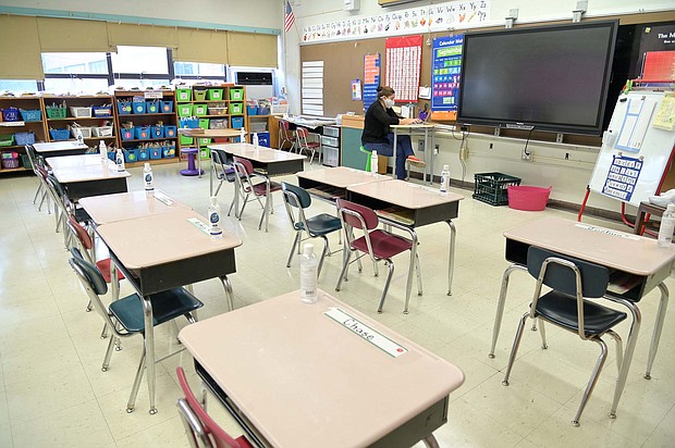 Jackie Sato, a teacher at Yung Wing School P.S. 124 wears a mask and teaches remotely from her classroom on September 24, 2020 in New York City.
Credit:	Michael Loccisano/Getty Images