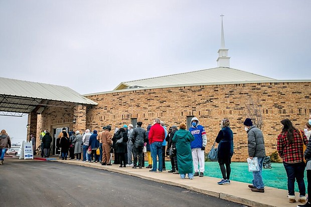 People line up for COVID-19 vaccinations outside Ebenezer Baptist Church in Oklahoma City, on Jan. 26, 2021.