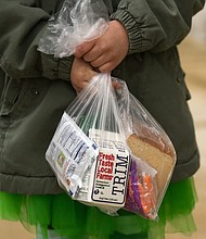 A child holds a packed lunch and breakfast as the Wyomissing Area School District handed out lunches (and breakfasts) for the first time Tuesday, March 17 in West Reading, Pennsylvania.
Credit: Lauren A. Little/MediaNews Group/Reading Eagle/Getty Images
