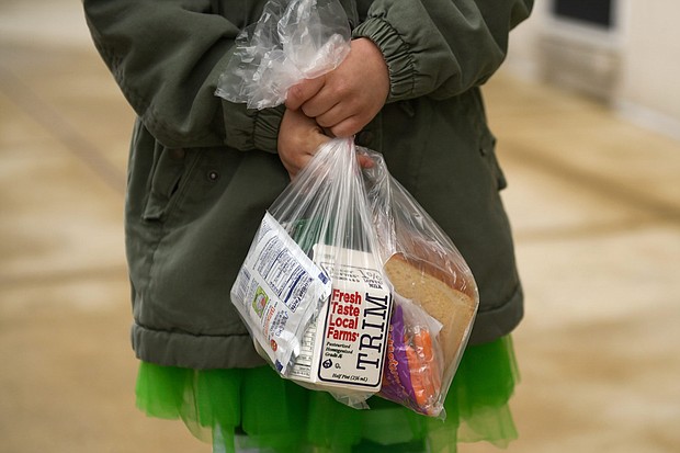 A child holds a packed lunch and breakfast as the Wyomissing Area School District handed out lunches (and breakfasts) for the first time Tuesday, March 17 in West Reading, Pennsylvania.
Credit:	Lauren A. Little/MediaNews Group/Reading Eagle/Getty Images