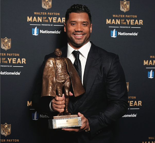 Seattle Seahawks quarterback Russell Wilson shows off his trophy after winning the Walter Payton NFL Man of the Year Award last weekend during the NFL Honors ceremony as part of Super Bowl LV.