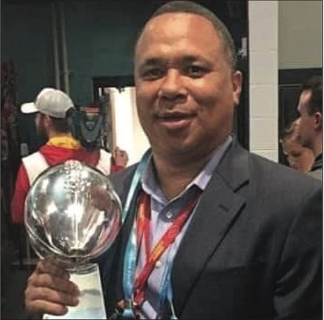 Michael Davis, personnel executive for the Kansas City Chiefs, holds the Vince Lombardi Trophy the team won as the 2020 Super Bowl champions.