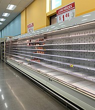 Shoppers are seen wandering next to near-empty shelves in a supermarket in Houston, Texas.
Credit:	Francois Picard/AFP/Getty Images