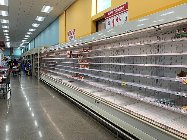 Shoppers are seen wandering next to near-empty shelves in a supermarket in Houston, Texas.
Credit:	Francois Picard/AFP/Getty Images