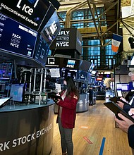 In this photo provided by the New York Stock Exchange, traders work on the floor, Friday, Feb. 19. 2021, in New York.
Credit:	Nicole Pereira/New York Stock