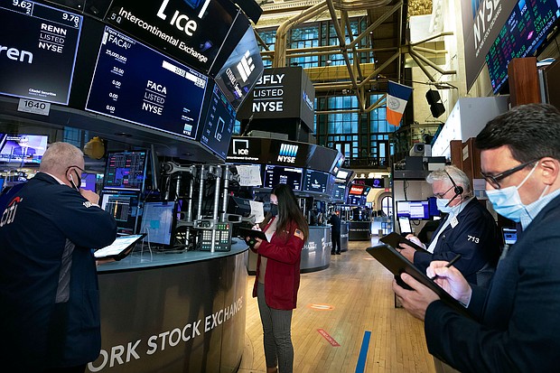In this photo provided by the New York Stock Exchange, traders work on the floor, Friday, Feb. 19. 2021, in New York.
Credit: Nicole Pereira/New York Stock