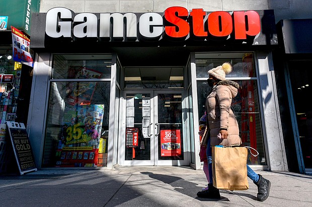 People walk past a GameStop store in Brooklyn, New York on Jan 28. GameStop shares rallied 67% ahead of the opening bell February 25, following another blockbuster day for the stock.
Credit:	Erik Pendzich/Shutterstock