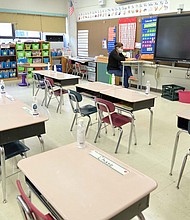 Jackie Sato, a teacher at Yung Wing School P.S. 124 wears a mask and teaches remotely from her classroom.
Credit:	Michael Loccisano/Getty Images