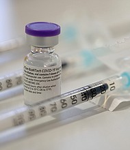 An ampoule containing the Corona vaccine from Biontech/Pfizer stands between syringes that have already been drawn up at the Bürgerheim retirement and nursing home.
Credit:	Sebastian Gollnow/picture alliance/Getty Images