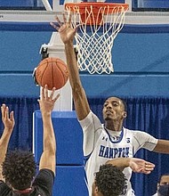 Hampton’s Dajour Dickens goes up to block a shot.