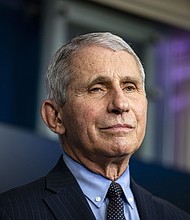 While tens of thousands of Americans are infected with the coronavirus each day and more research suggests variants threaten another surge, some state leaders are loosening Covid-19 restrictions against the recommendations of health experts.
Credit:	Al Drago/Bloomberg/Getty Images