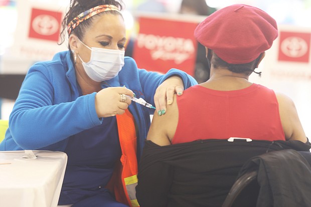 Catherine Hinton, 65, of Richmond receives the new, single-dose Johnson & Johnson COVID-19 vaccine during a mass vaccination event Monday at Richmond Raceway sponsored by the Richmond and Henrico health districts. It was the first time the newly approved Johnson & Johnson vaccine was administered locally in vaccine clinics. The Moderna and Pfizer-BioNTech vaccines require two doses for full vaccination.