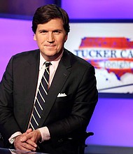 Tucker Carlson, host of "Tucker Carlson Tonight," poses for photos in a Fox News Channel studio on March 2, 2017, in New York.
Credit:	Richard Drew/AP