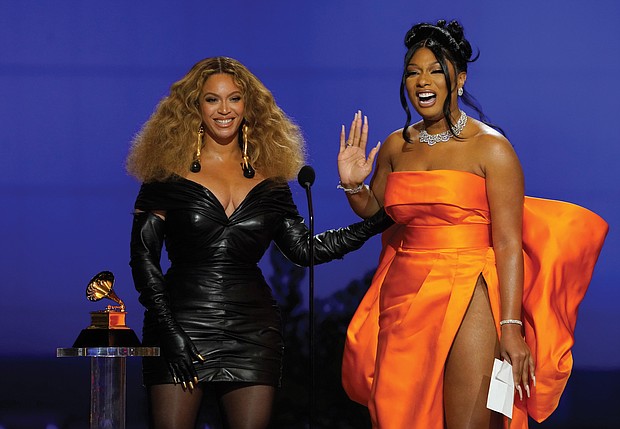 Beyonce, left, and Megan Thee Stallion accept the award for best rap song for “Savage” at the 63rd Annual Grammy Awards held Sunday at the Los Angeles Convention Center.