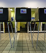A row of voting booths are shown at a Chicago polling place in a 2015 file photo