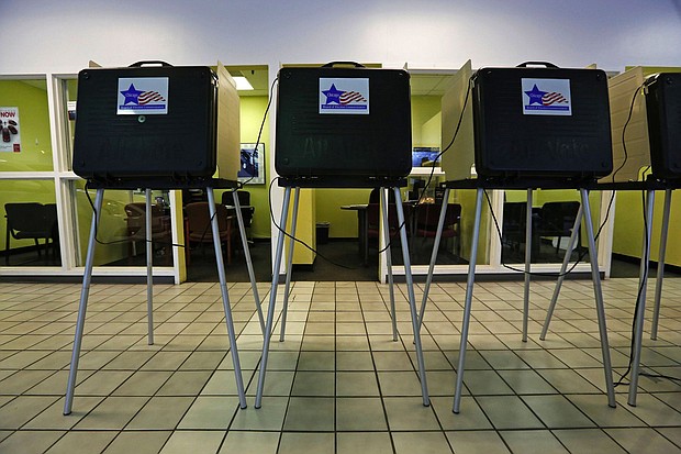 A row of voting booths are shown at a Chicago polling place in a 2015 file photo