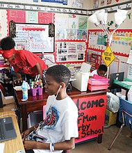 Tisha Erby keeps things moving and the learning going for her four school-age sons in their family’s home. The living room has been turned into a vibrant classroom, with desks and laptops for each of the boys. They are, from left, Emanuel, 3, a pre-schooler at Summer Hill Elementary; Christopher Jr., 13, a seventh-grader at River City Middle School; Elijah, 5, a kindergartner at J.L. Francis Elementary; and Lamar, 11, a sixth- grader at River City Middle. Seated in a high chair in the room, but not pictured, is year- old Tristan, who was working on his own activities given to him by his mom.