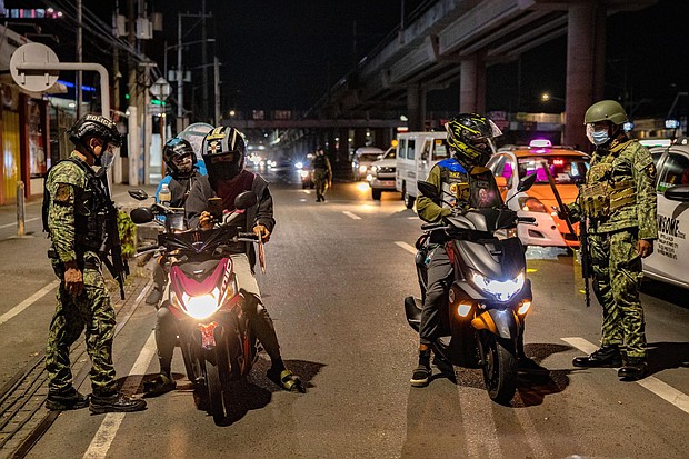 The Philippine National Police has deployed thousands of officers to help enforce the lockdown rules that have been imposed on Manila and surrounding provinces.
Mandatory Credit:	Ezra Acayan/Getty Images