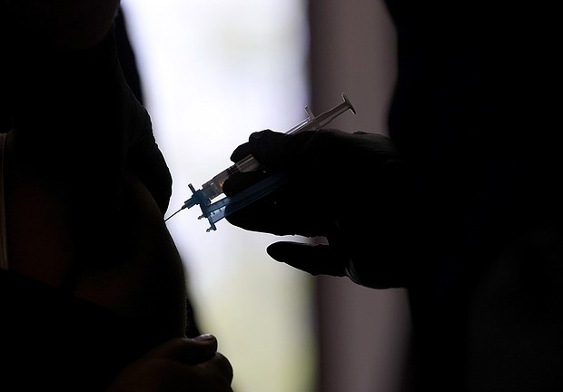 A Maryland resident receives the Moderna Covid-19 vaccine at a vaccination clinic on March 23. Structural racism is a concern that keeps some people of color from getting vaccinated during the pandemic.
Mandatory Credit:	Win McNamee/Getty Images