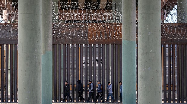 Undocumented immigrants are seen walking along the border wall on March 17 in Ciudad Juarez, Mexico. US Customs and Border Protection says it is deploying more agents to the US-Mexico border.
Mandatory Credit:	John Moore/Getty Images