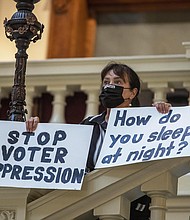 Ann White of Roswell protesting
