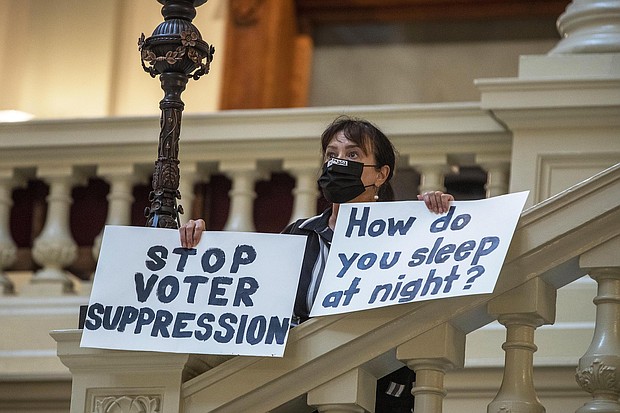 Ann White of Roswell protesting