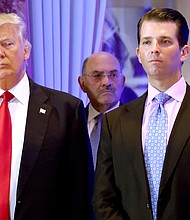 Donald Trump once said he calculated his net worth, to a degree, on his "feelings," and that he put the "best spin" on some of the assets. He is seen here in 2017 with Trump Org Chief Financial Officer Allen Weisselberg (center) and Donald Trump Jr.
Mandatory Credit:	TIMOTHY A. CLARY/AFP/Getty Images