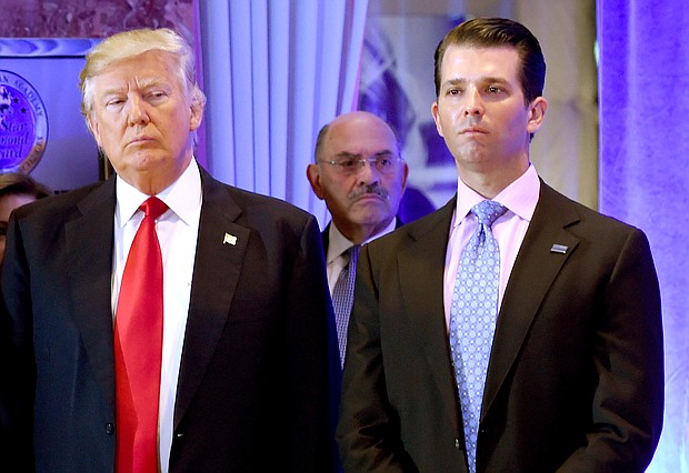 Donald Trump once said he calculated his net worth, to a degree, on his "feelings," and that he put the "best spin" on some of the assets. He is seen here in 2017 with Trump Org Chief Financial Officer Allen Weisselberg (center) and Donald Trump Jr.
Mandatory Credit:	TIMOTHY A. CLARY/AFP/Getty Images