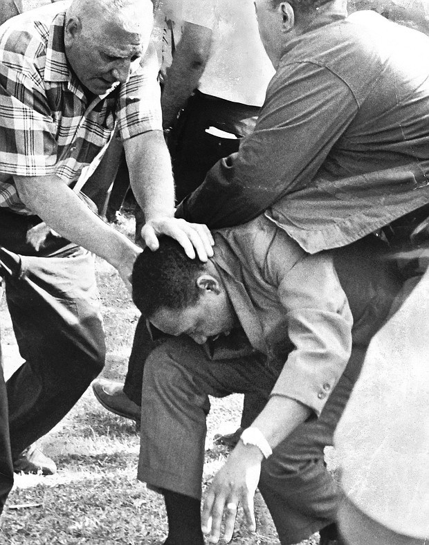 Aides shield the Rev. Martin Luther King Jr. after he was struck by a rock in Marquette Park during an Aug. 5, 1966,