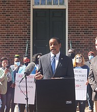 Lt. Gov. Justin E. Fairfax speaks, while state Sen. Joseph D. “Joe” Morrissey stands by, during a rally and news conference Monday at the Bell Tower in Capitol Square that drew more than a dozen people.