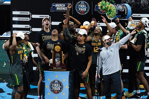 Baylor players and coaches celebrate after winning the NCAA championship game 86-70 against undefeated Gonzaga on Monday night at Lucas Oil Stadium in Indianapolis, Ind.