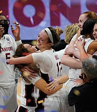 Stanford players celebrate after clinching the NCAA crown Sunday at the buzzer with a 54-53 victory over Arizona at the Alamodome in San Antonio, Texas.