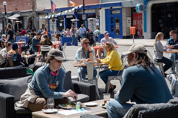 People are seen dining outdoors at a restaurant in Ann Arbor, Michigan, on April 4. Michigan is already in the middle of a violent Covid-19 surge, and one epidemiologist says other states should be paying close attention.
Mandatory Credit:	Emily Elconin/Reuters