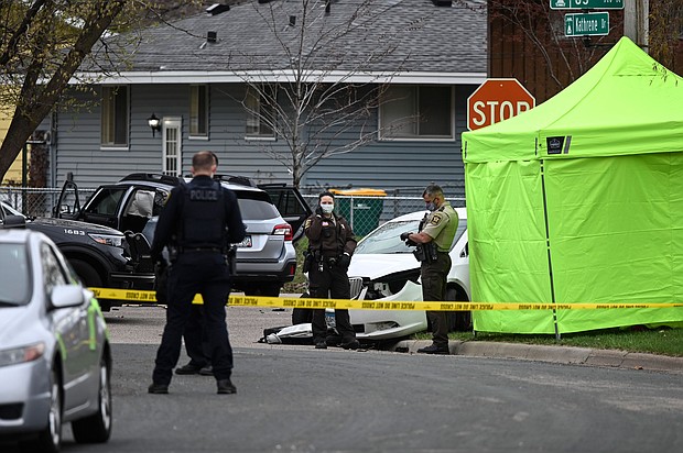 The Minnesota National Guard was deployed overnight to the Minneapolis suburb of Brooklyn Center after crowds protested the death of a man in an officer-involved shooting and car crash on April 11. Hennepin County Sheriffs and Brookly Center Police are seen standing near a tent.
Mandatory Credit:	Aaron Lavinsky/Star Tribune/Getty Images