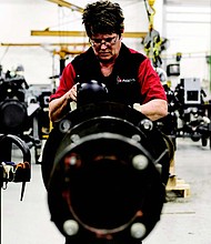 An assembly associate at the AGCO Jackson, MN facility begins building a hydraulic pump that will allow the machinery’s operator to control its movement.