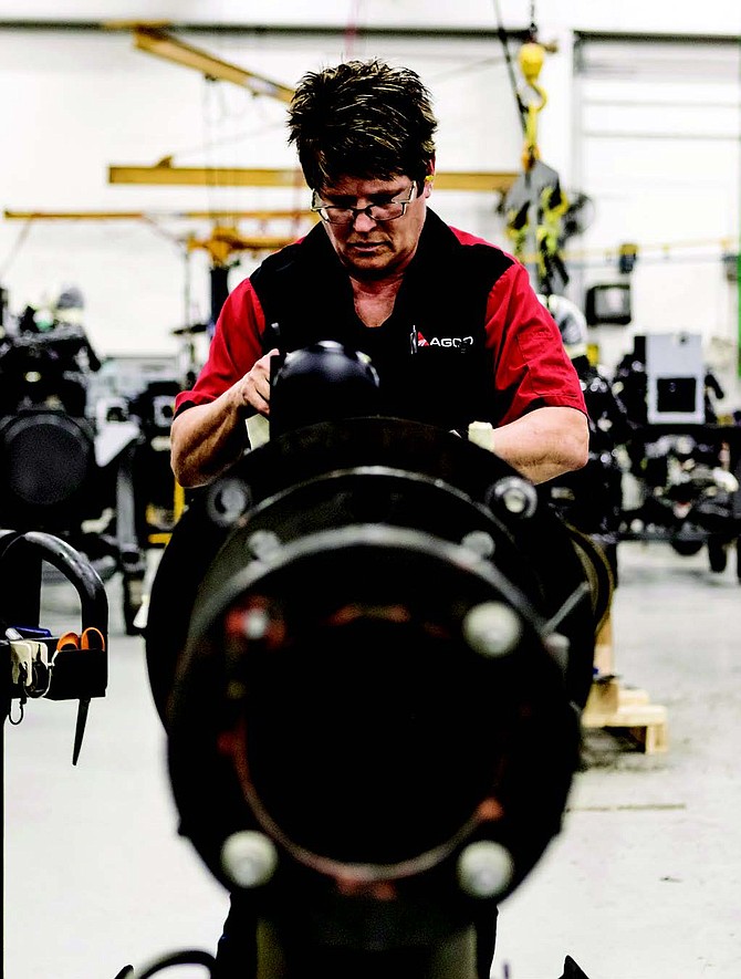 An assembly associate at the AGCO Jackson, MN facility begins building a hydraulic pump that will allow the machinery’s operator to control its movement.