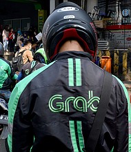 Grab announced April 13 that it would merge with a special purpose acquisition company (SPAC) backed by Altimeter Capital in a deal that would pave the way for a New York listing and value Grab at about $39.6 billion.
Mandatory Credit:	Goh Chai Hin/AFP/Getty Images
