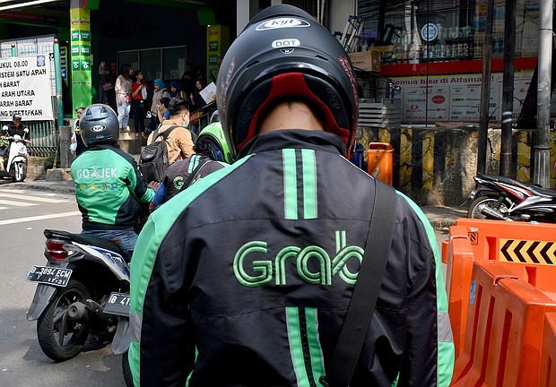 Grab announced April 13 that it would merge with a special purpose acquisition company (SPAC) backed by Altimeter Capital in a deal that would pave the way for a New York listing and value Grab at about $39.6 billion.
Mandatory Credit:	Goh Chai Hin/AFP/Getty Images