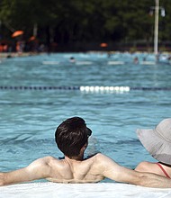 Coronavirus can spread between people via respiratory droplets, air or surfaces, but the US Centers for Disease Control and Prevention isn't aware of any evidence about coronavirus spreading to people through the water in pools.
Mandatory Credit:	Anthony Behar/Sipa USA/AP