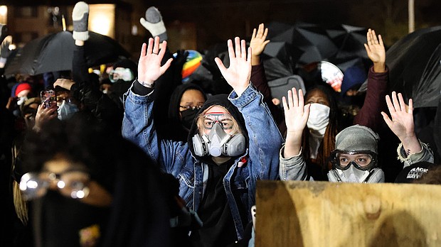 Demonstrators hold their hands up as they protest outside of the Brooklyn Center police station on April 14 in Brooklyn Center, Minnesota. This is the fourth day of protests in the suburban Minneapolis city following the fatal shooting of 20-year-old Daunte Wright by police officer Kimberly Potter.
Mandatory Credit:	Scott Olson/Getty Images