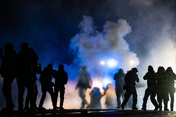 Authorities fire gas munitions at demonstrators gathered outside the Brooklyn Center Police Department to protest the shooting death of Daunte Wright on April 13 in Brooklyn Center, Minn.
Mandatory Credit:	John Minchillo/AP