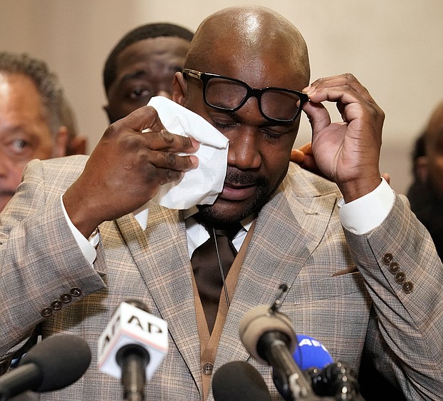 George Floyd’s brother, Philonise Floyd, wipes his eyes during a news conference after the verdict was read Tuesday in Minneapolis in which former police officer Derek Chauvin was convicted of the murder of George Floyd.  Below, Andre Tolleris waves a flag and yells in jubilation to passing motorists Tuesday at Monument and Allen avenues. Many of the drivers and passengers honked their horns in celebration.