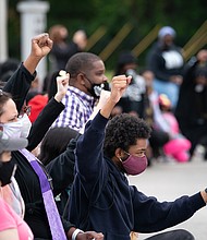 Erving Goldsberry (right) kneels with his fist in the air joining demonstrators blocking bridge traffic during a protest march on April 24 in Elizabeth City, North Carolina. Protestors called for the release of body camera footage from the shooting death of Andrew Brown Jr. on April 21.
Mandatory Credit:	Sean Rayford/Getty Images