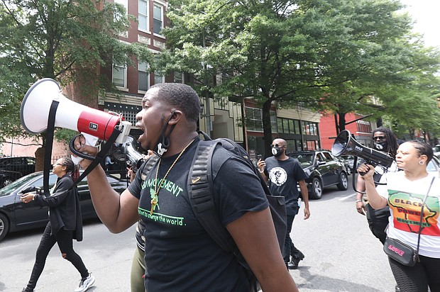 Corey Stuckey, a senior at George Wythe High School, leads several dozen community members in a rally and march on April 23 in Downtown, demanding that city and school officials expedite plans to build a replacement for the dilapidated school in South Side. The group also called for students to be at the table for decision-making. The march went from the Maggie L. Walker statue at Adams and Broad streets to City Hall at 9th and Broad streets.