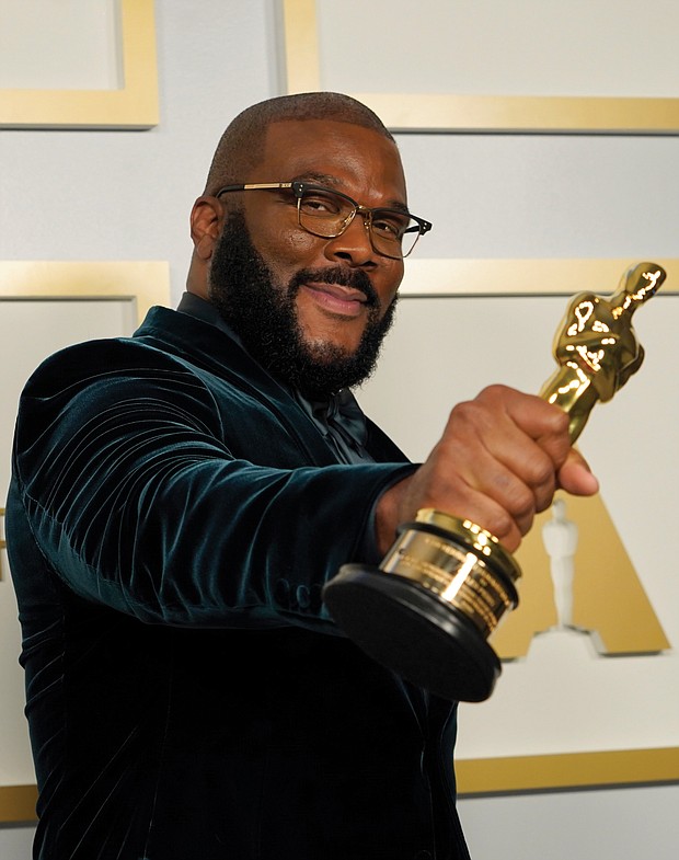 Tyler Perry, winner of the Jean Hersholt Humanitarian Award, holds his Oscar at the Academy Awards in Los Angeles.